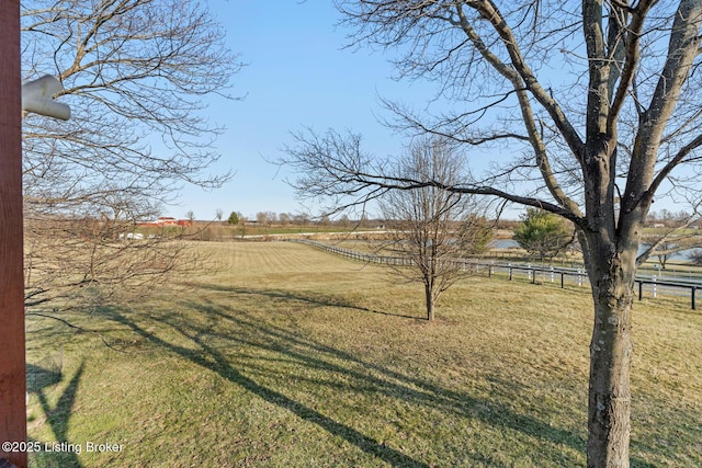 view of yard with a rural view and fence