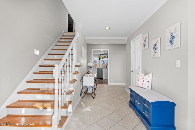 stairway with tile patterned flooring, crown molding, and baseboards