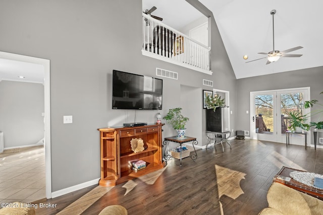 living room featuring wood finished floors, a ceiling fan, and visible vents