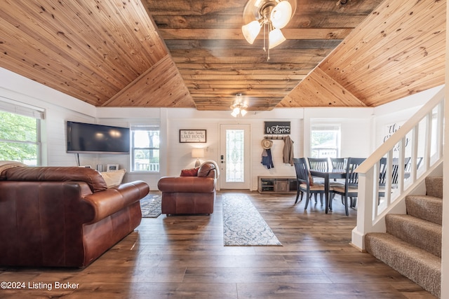 living room featuring a wealth of natural light, stairway, dark wood finished floors, and wood ceiling