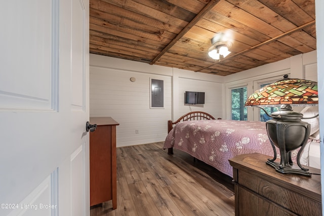 bedroom with wood ceiling, electric panel, and wood finished floors