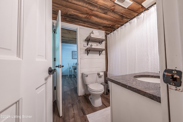 full bath featuring toilet, visible vents, wood finished floors, and vanity