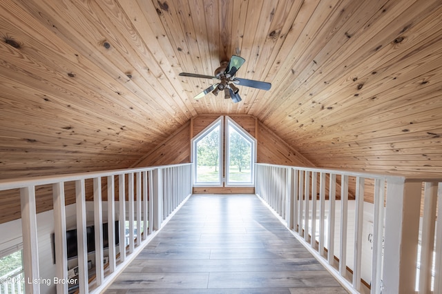 additional living space with lofted ceiling, hardwood / wood-style flooring, wood ceiling, and ceiling fan