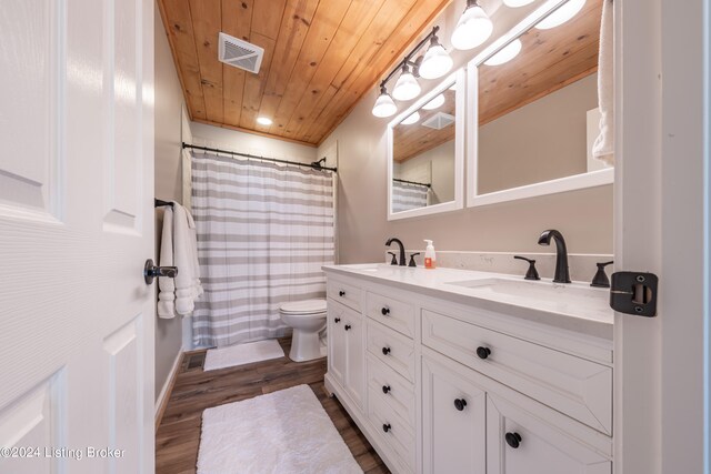 full bathroom featuring toilet, wooden ceiling, visible vents, and a sink