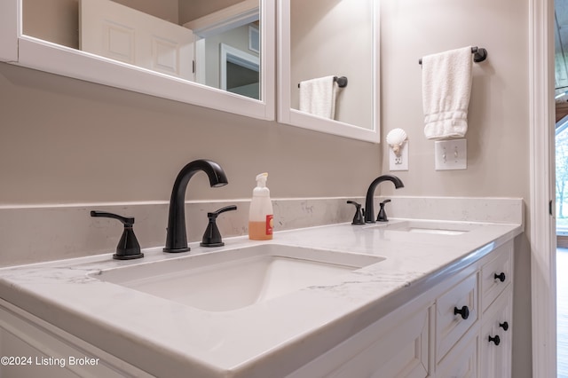 bathroom featuring double vanity and a sink