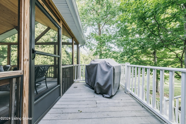 wooden terrace with a grill