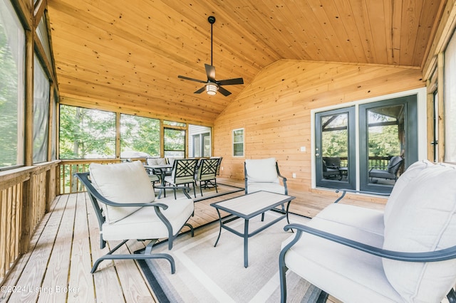 sunroom featuring lofted ceiling, ceiling fan, wooden ceiling, and a healthy amount of sunlight