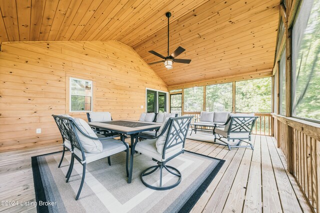 sunroom / solarium featuring lofted ceiling, plenty of natural light, wood ceiling, and a ceiling fan