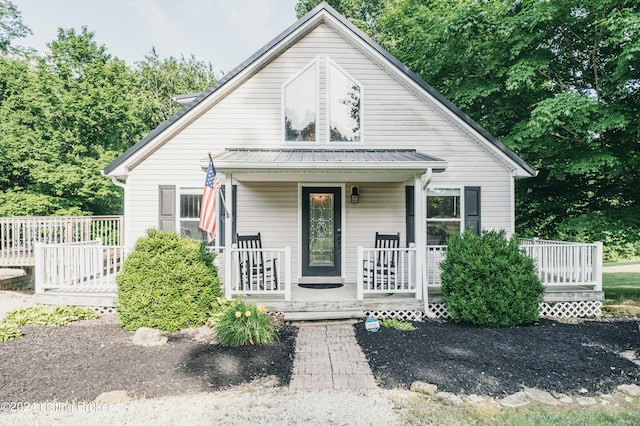 bungalow-style house with covered porch and metal roof