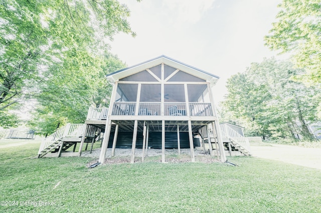 rear view of property featuring ceiling fan, stairs, a deck, and a yard