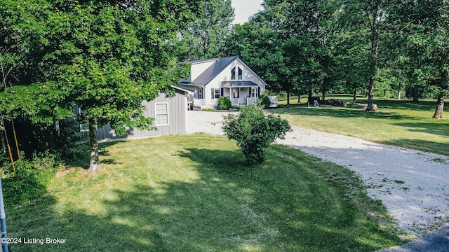 view of front of home with an outdoor structure, covered porch, driveway, and a front lawn