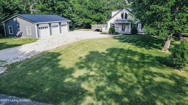 view of yard featuring a garage and a porch