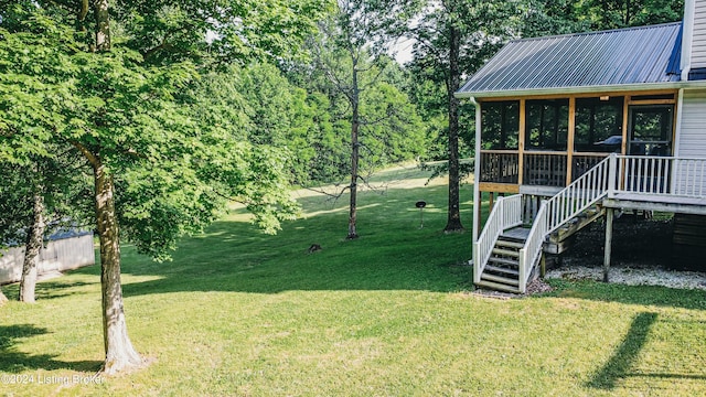 view of yard with stairway and a sunroom