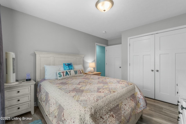 bedroom with a closet and wood finished floors