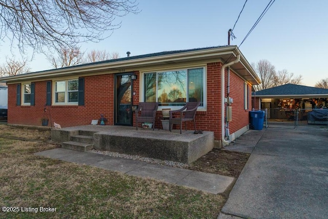 view of front facade featuring brick siding and a front yard