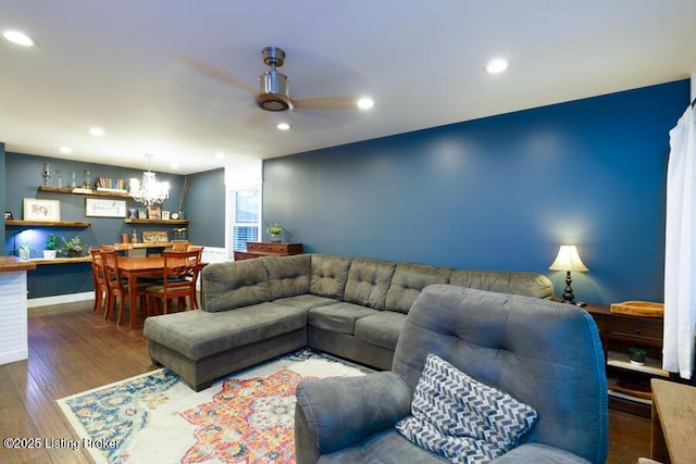 living room with recessed lighting, baseboards, dark wood-style floors, and ceiling fan with notable chandelier