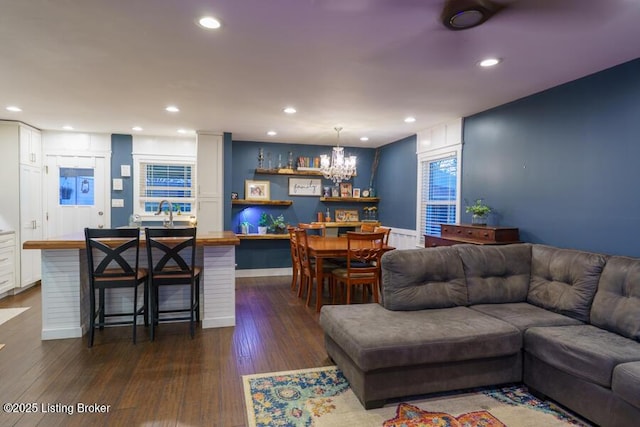 living area with recessed lighting and dark wood-type flooring