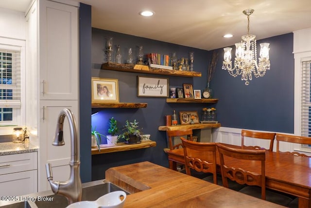 dining area with recessed lighting and an inviting chandelier