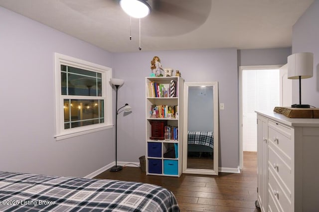 bedroom featuring dark wood-style floors, a ceiling fan, and baseboards