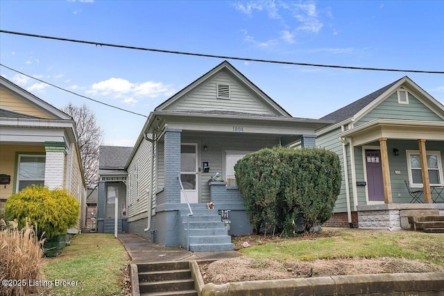 shotgun-style home featuring covered porch