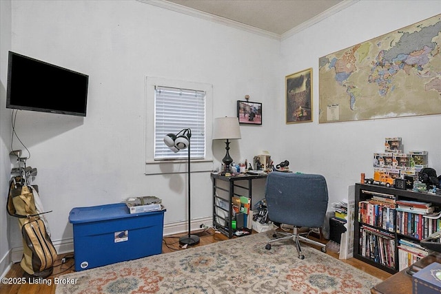 office space with baseboards, crown molding, and wood finished floors