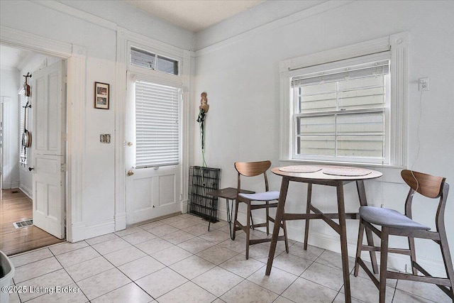 interior space featuring a wealth of natural light, baseboards, and light tile patterned floors