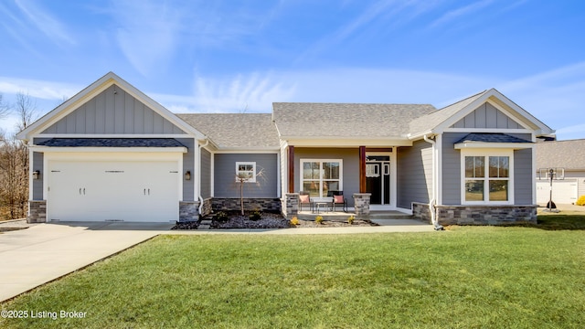 craftsman-style house with covered porch, stone siding, concrete driveway, board and batten siding, and a front yard