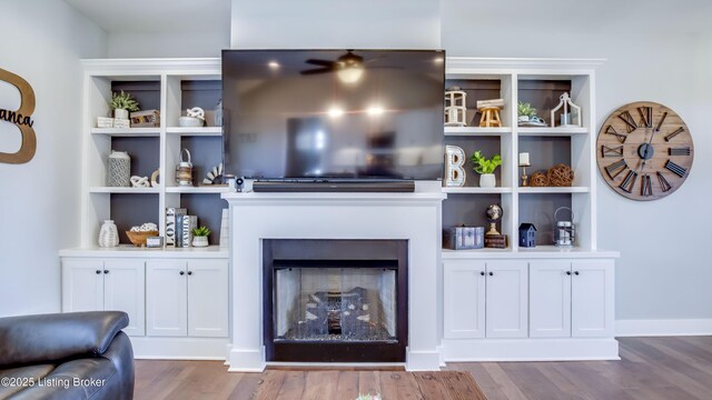 living area featuring a fireplace and dark wood-style flooring