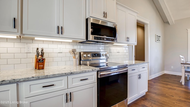 kitchen featuring baseboards, white cabinets, dark wood-style floors, stainless steel appliances, and backsplash