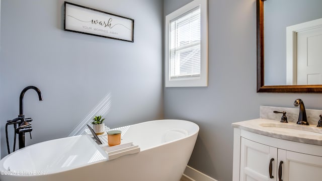 full bath with a freestanding bath and vanity