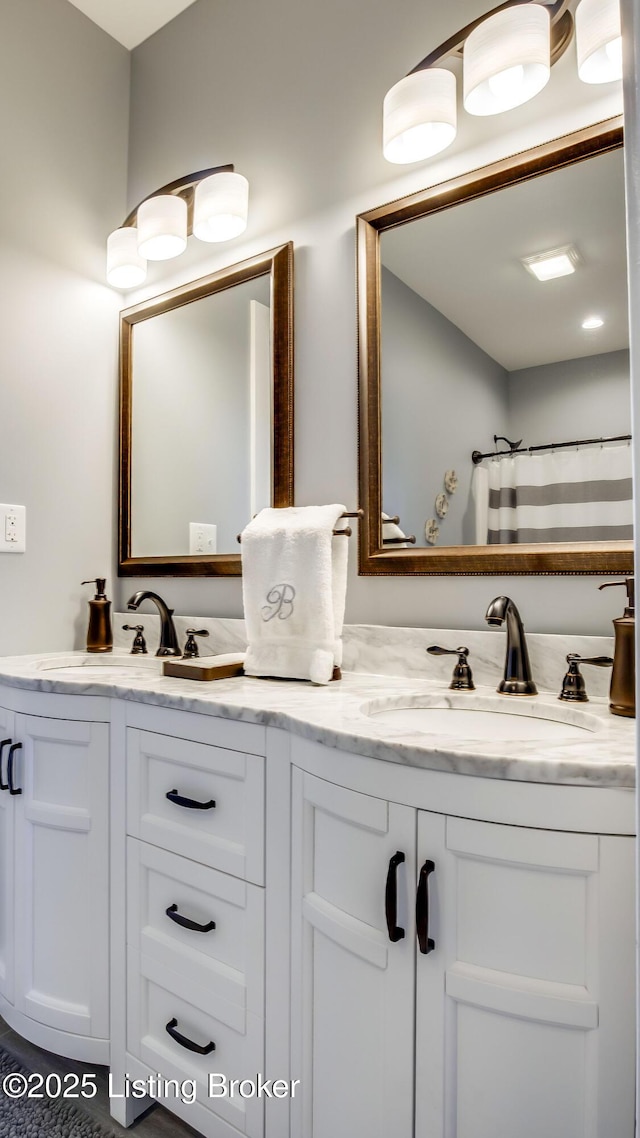 bathroom with double vanity and a sink