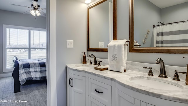 bathroom with double vanity, ceiling fan, and a sink