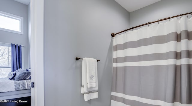 full bathroom featuring curtained shower and ensuite bathroom