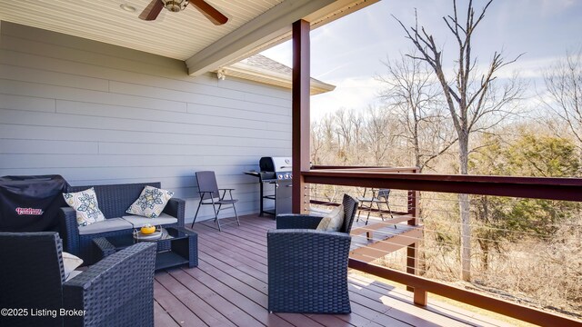 wooden terrace with area for grilling, outdoor lounge area, and a ceiling fan