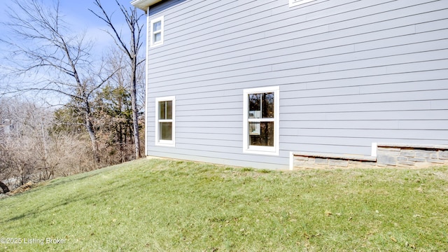 view of side of home featuring a yard