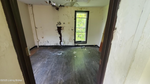 empty room with baseboards and wood finished floors