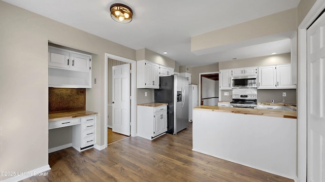 kitchen with dark wood-style flooring, stainless steel appliances, wooden counters, built in study area, and white cabinetry