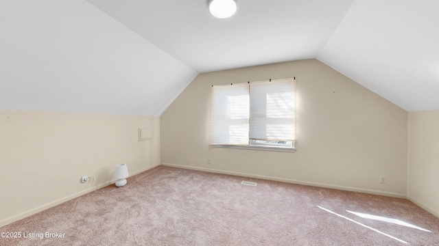 bonus room with carpet floors, baseboards, visible vents, and lofted ceiling