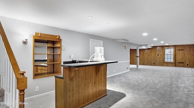 kitchen featuring recessed lighting, light colored carpet, dark countertops, and baseboards