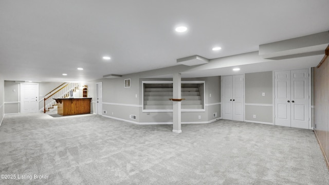 finished below grade area featuring recessed lighting, carpet flooring, and stairway