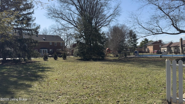 view of yard featuring a residential view and fence