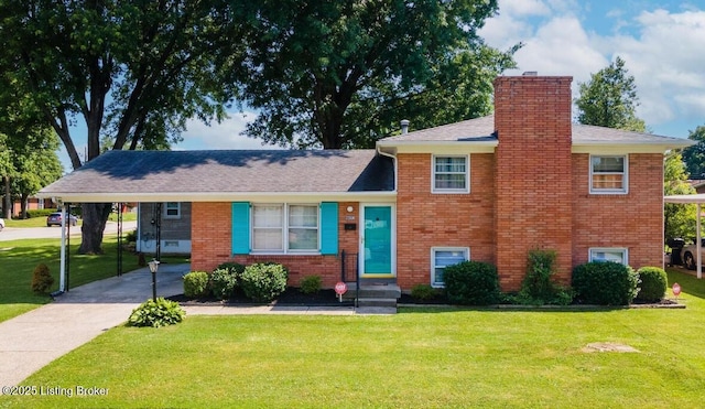 split level home with a carport, brick siding, a chimney, and a front yard