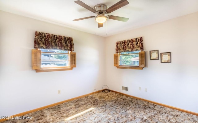 unfurnished room featuring carpet floors, visible vents, ceiling fan, and baseboards