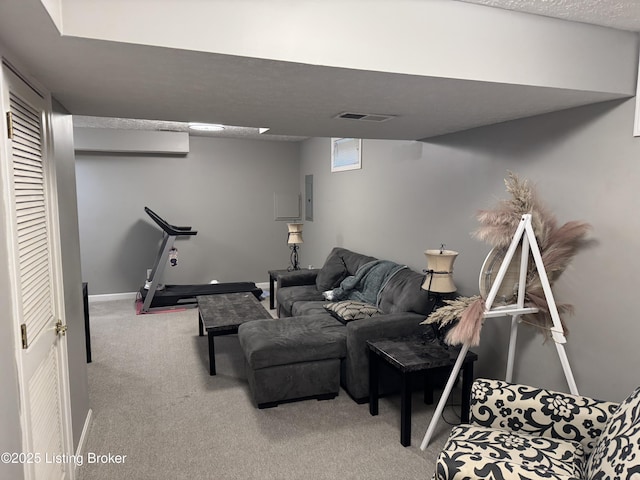 carpeted living area with baseboards, a textured ceiling, visible vents, and electric panel