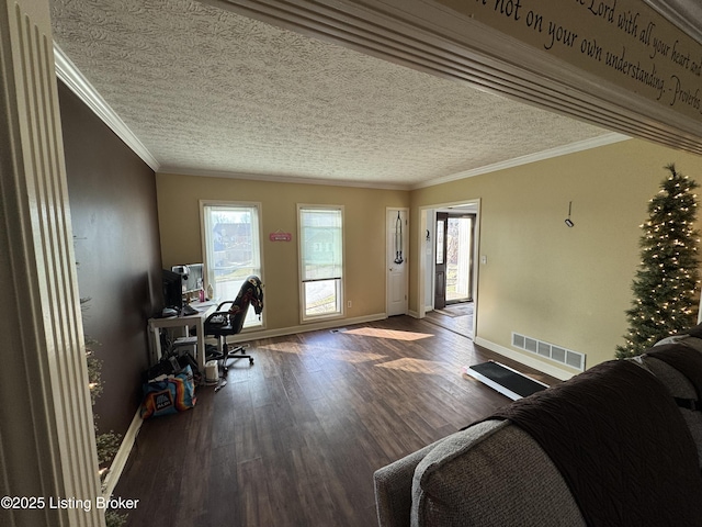 office space featuring baseboards, crown molding, visible vents, and wood finished floors