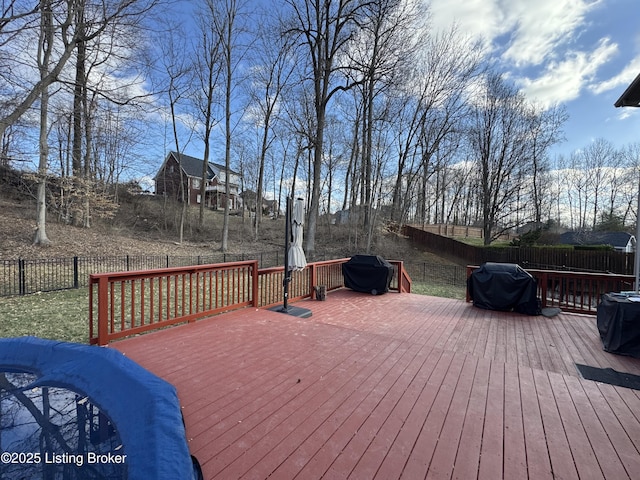 wooden deck with a fenced backyard