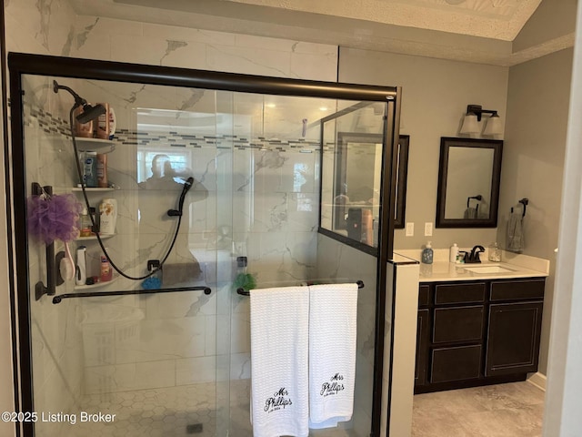 bathroom featuring a stall shower and vanity