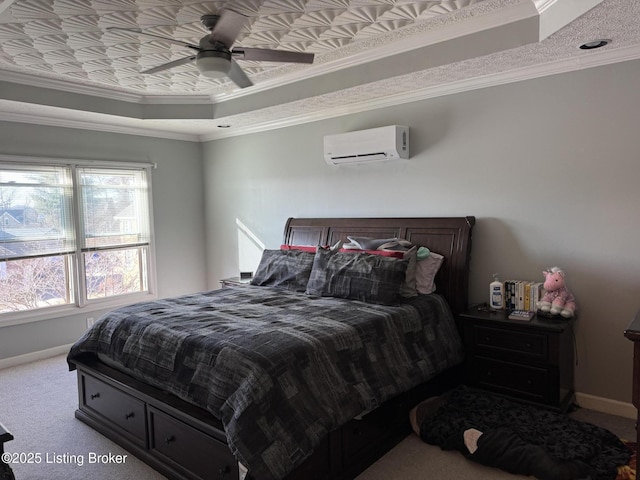 carpeted bedroom with crown molding, a raised ceiling, an AC wall unit, ceiling fan, and baseboards