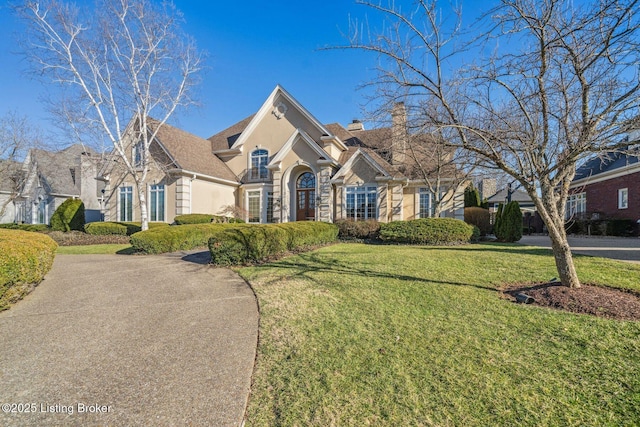 view of front of property featuring a front lawn and a chimney