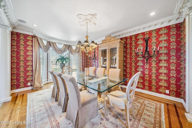 dining room with crown molding, light wood-style floors, a notable chandelier, and baseboards